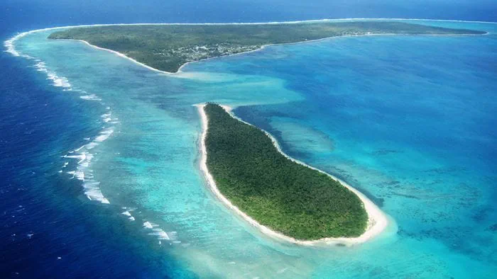 Aerial view of the islands of the Kingdom of Tonga on a bright, clear day