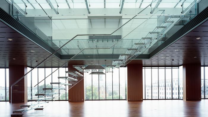 The steel-framed and glazed staircase turns into one entirely of structural glass. Photo: Adam Mork