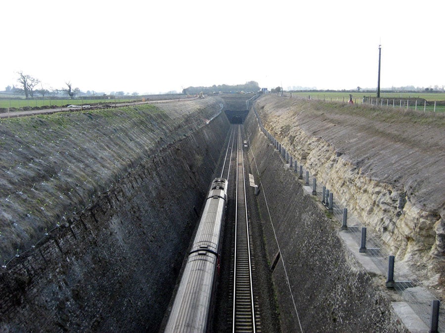 Train travelling through a deep cutting in the UK
