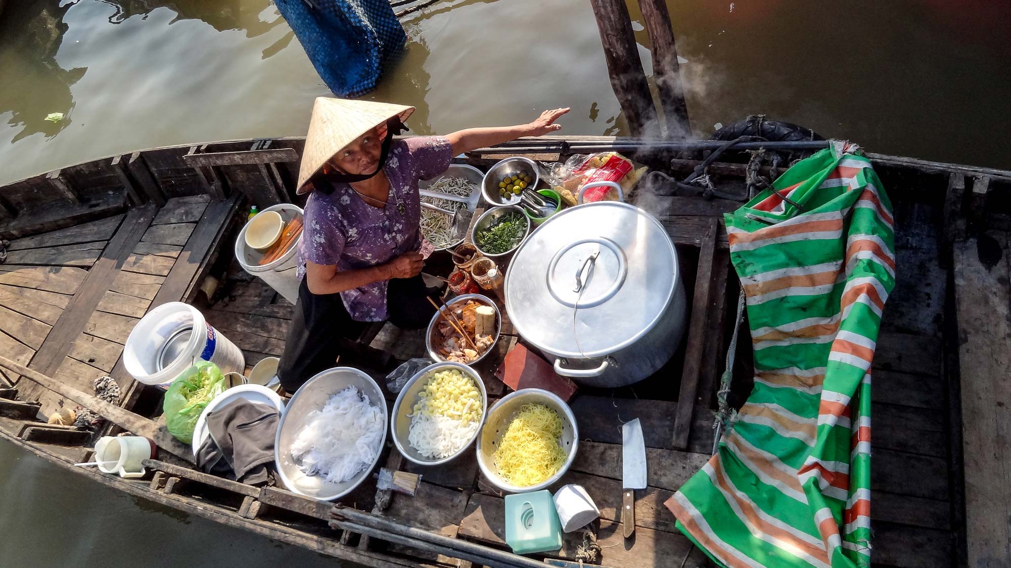 Woman on boat cooking food