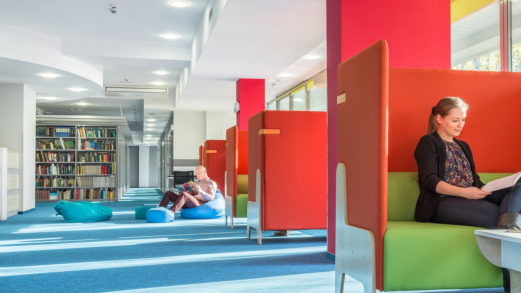 Library with individual study area with red partition and green sofa