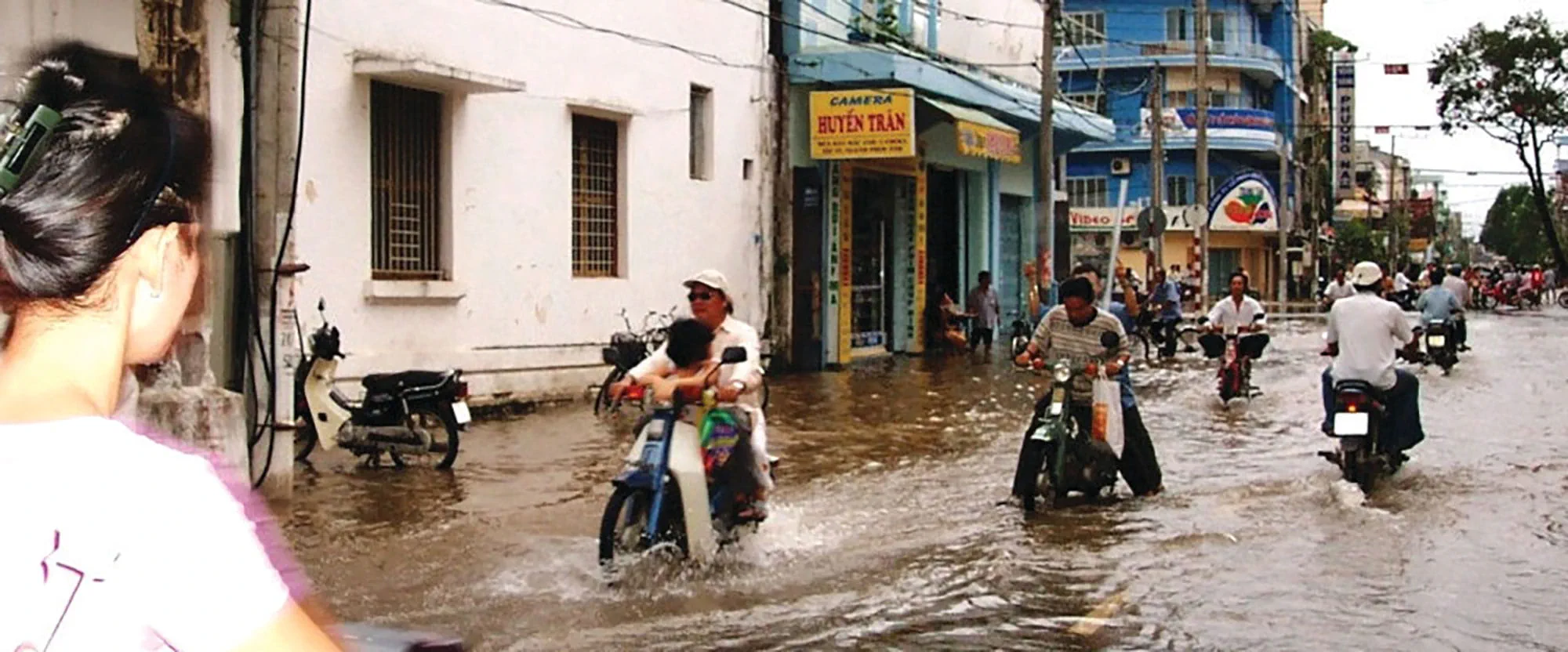 Flooded Asian street scene with mopeds