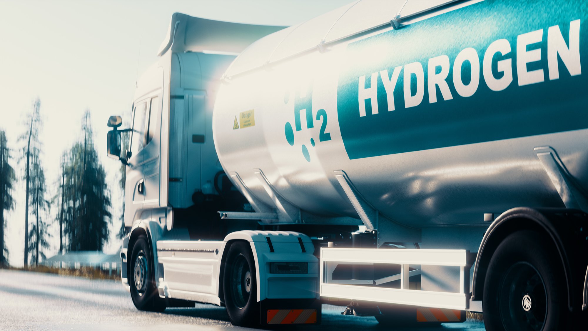 Image of semi trailer truck on road with the word hydrogen printed on its tanker