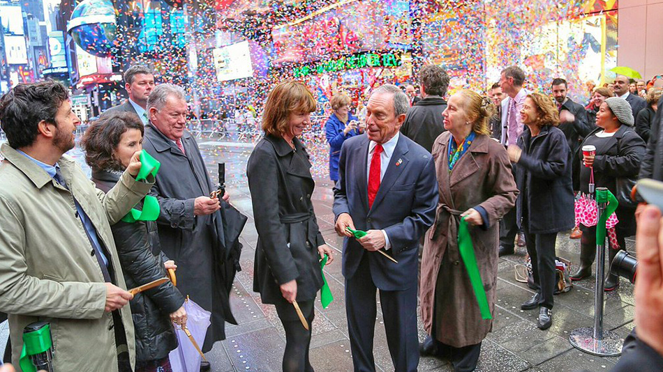 Newman (second from right, in background) with Janette Sadik-Khan and Michael Bloomberg (both center) at the 2013 ribbon cutting for a Times Square pedestrian plaza