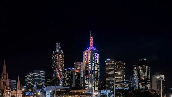 The spire of 101 Collins Street lighting up the Melbourne cityscape