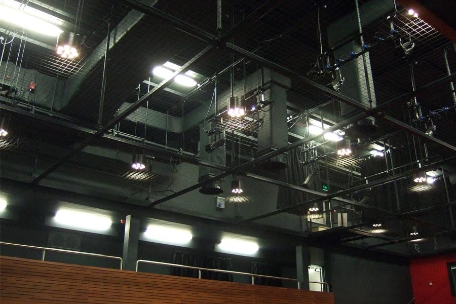 A tension wire grid above the auditorium provides a safe environment for technical theatre training.