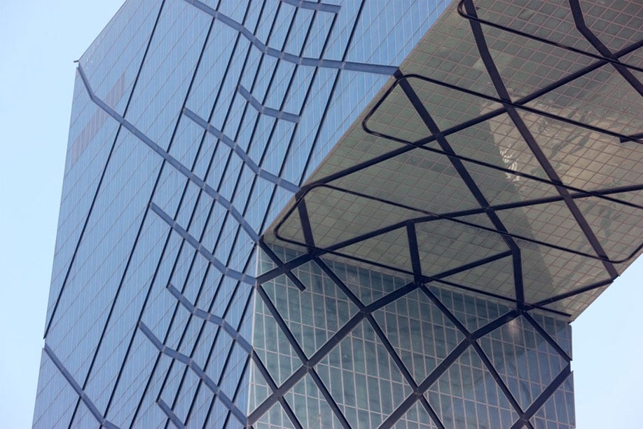 The irregular grid provides support for the building. The greater the forces in the structure, the denser the pattern.