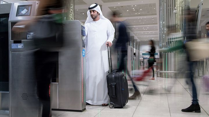 A passenger at Dubai Airport travels through the airport