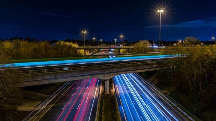 Photo of M50 motorway at night showing trail of car lights in both directions.