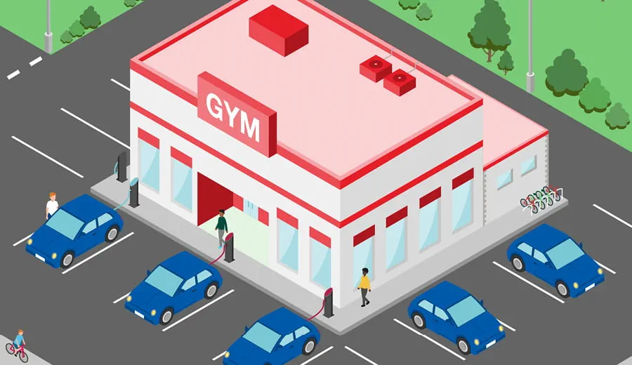 Brightly coloured illustration showing a large block with a gym with parking and charging stations for EV cars. 