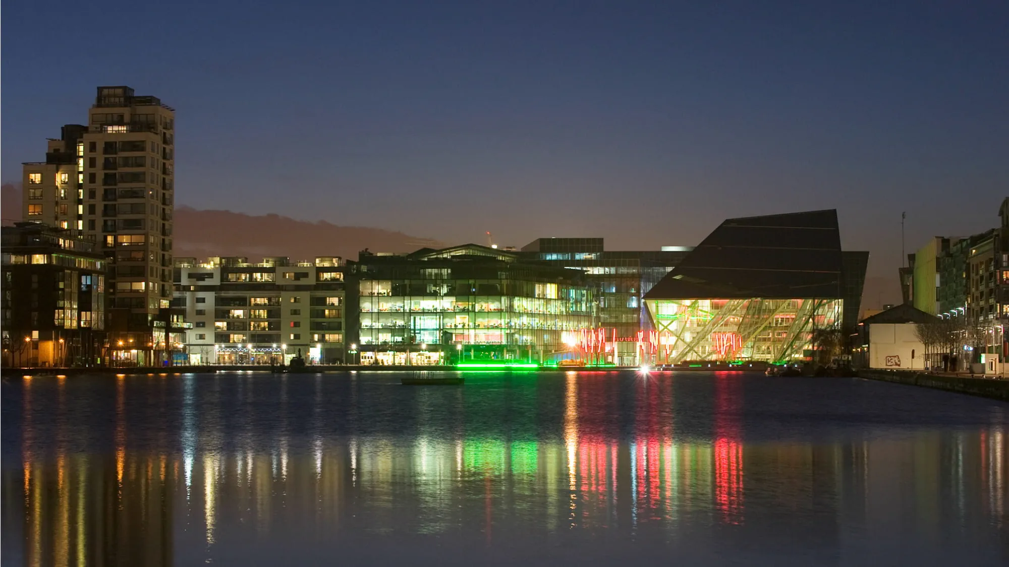 View of the Bord Gáis Energy Theatre and surrounding buildings on Grand Canal Dock, by night.