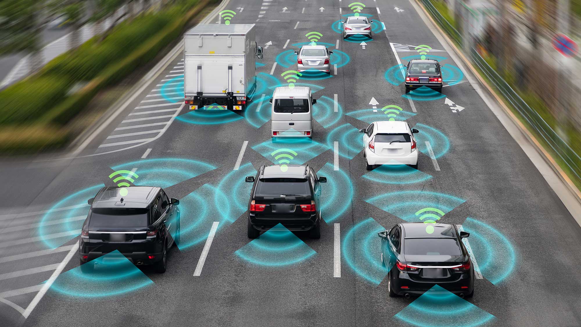 Stock image showing vehicles on a four-lane motorway with wireless symbols between them.