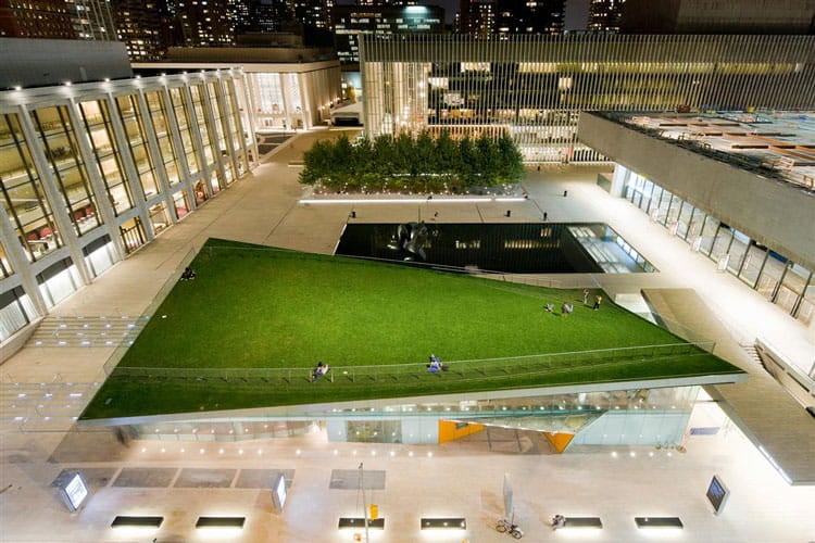 The public lawn twists up from plaza level, helping isolate visitors from traffic noise from a busy nearby street.