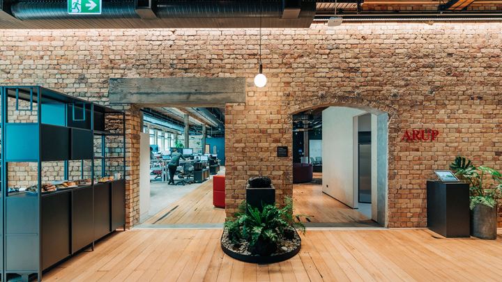 Modern workspace with natural light, plants, seating and recreation space
