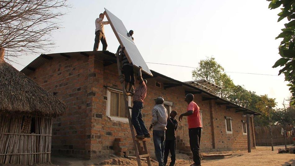 An MSF team installing solar panels