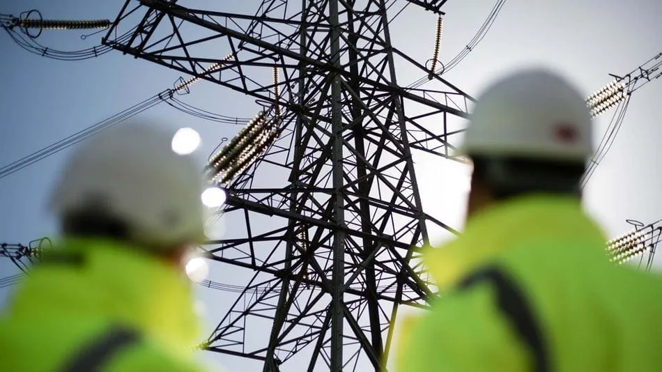 Pylon and engineers. Credit: National Grid