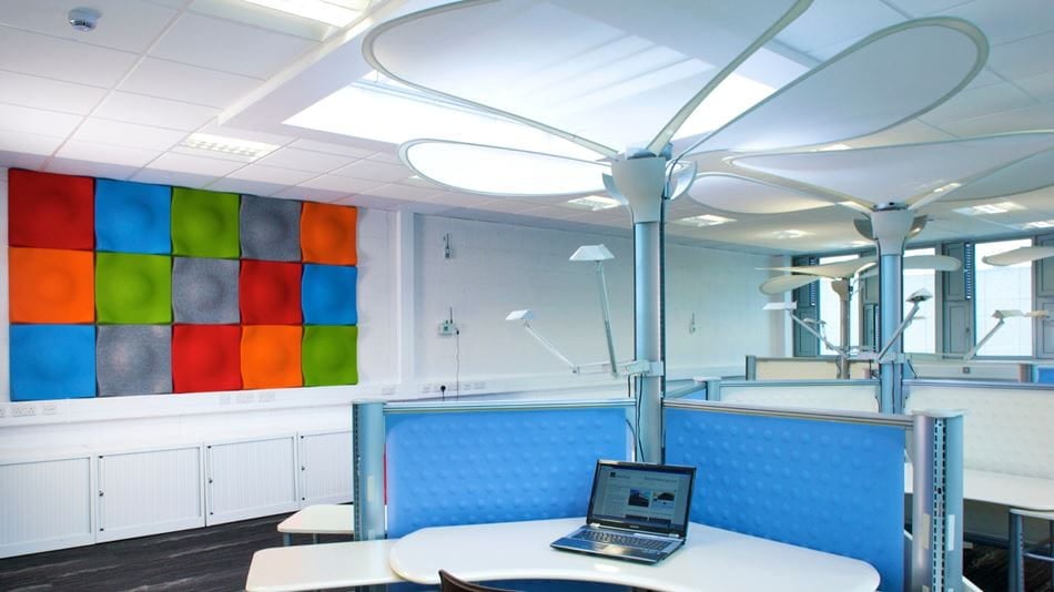 Desk and colourful wall inside the National Sustainable Building Energy Test Bed.