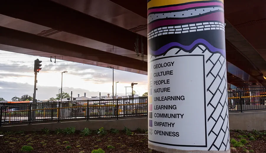Indigenous knowledge is presented on a pier under a road bridge