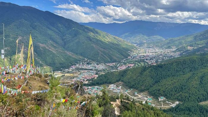 Aerial view of Bhutan showing a town or city and surrounding natural environment including forests and mountains