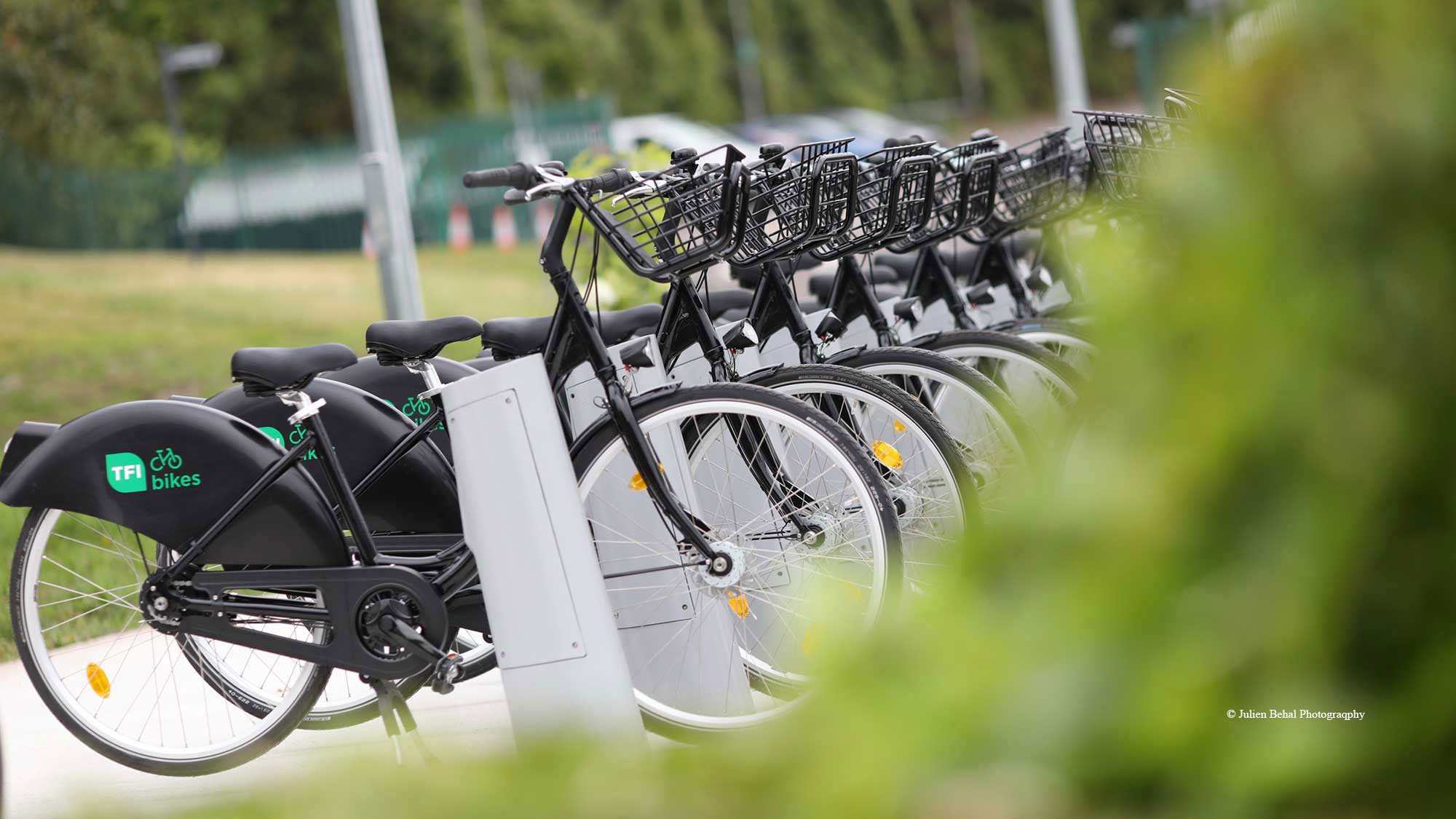 Bicycles in a row at a docking station.