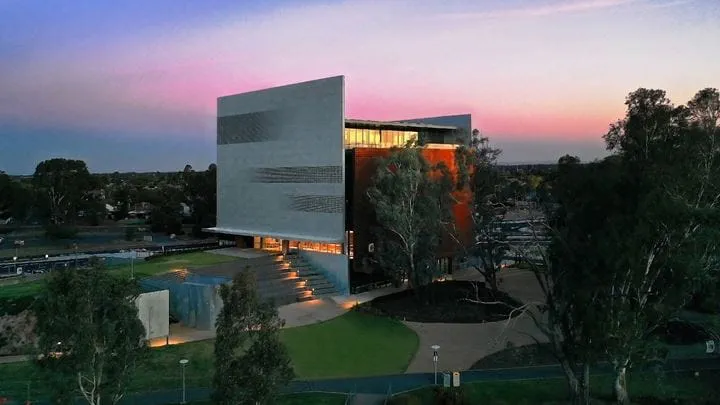 View at dusk of Shepparton Art Museum and surrounding park and lake