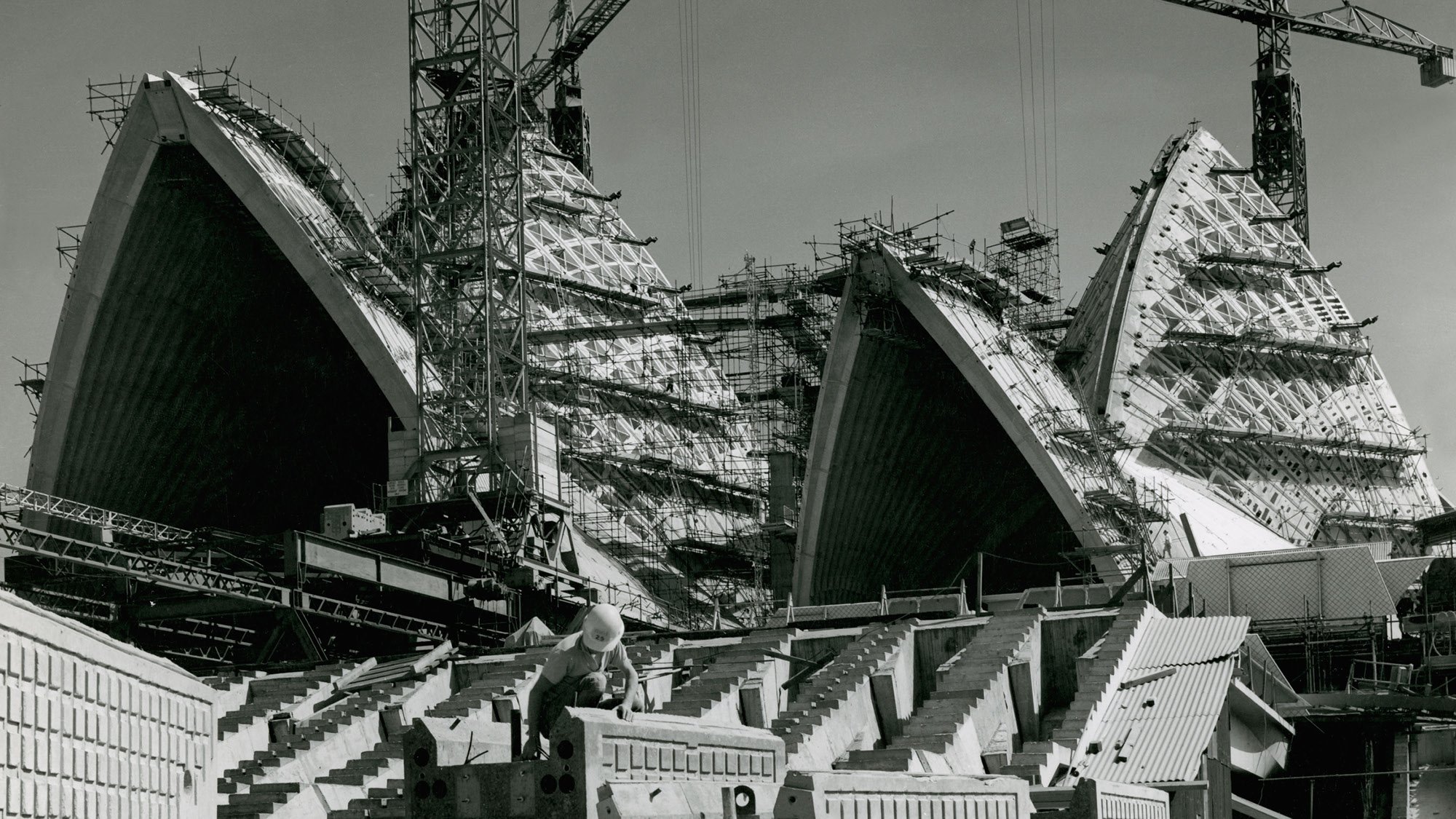 A black and white photograph of the roof sails at the Sydney Opera House during construction