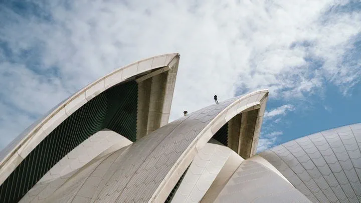 Close up view of men climbing the roof sails on the Sydney Opera House