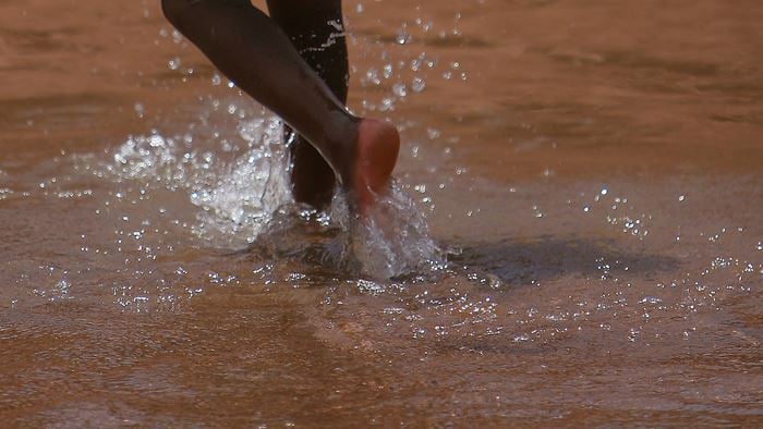 Child running through the water