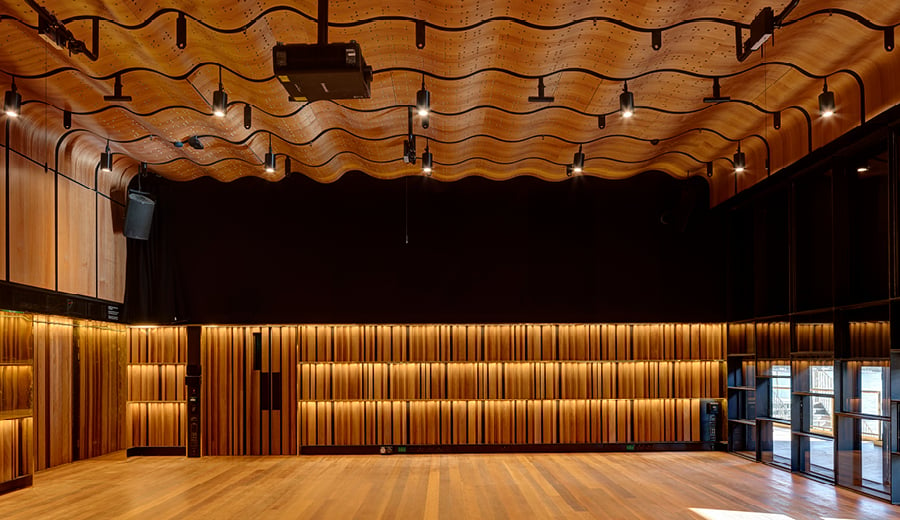 Inside a new theatre at Walsh Bay Arts Precinct. The theatre has high ceilings, timber furnishings and panels.