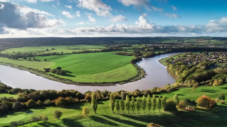 The Avon river running through a green landscape