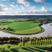 The Avon river running through a green landscape