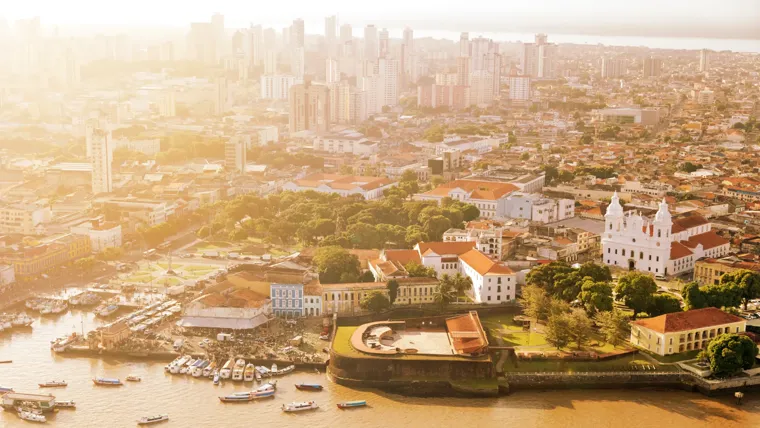 A city with many buildings and boats.