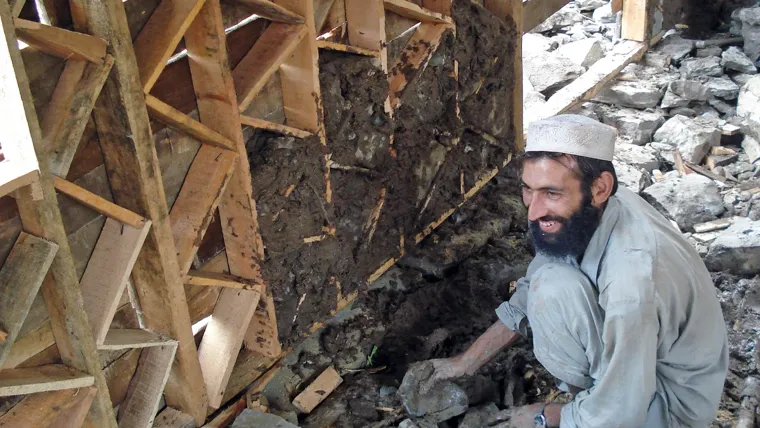A man sitting helping to construct a house