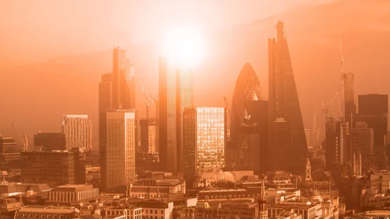 London city skyline with the sun setting
