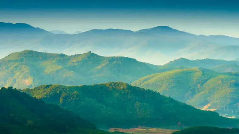 A valley with mountains in the background.