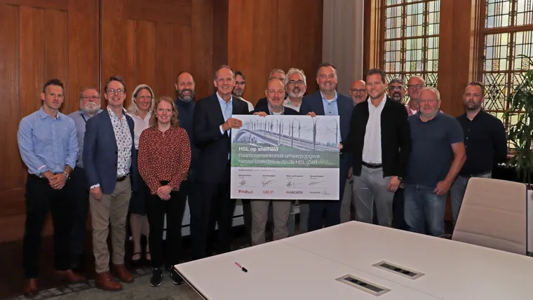 A group of people holding a sign.
