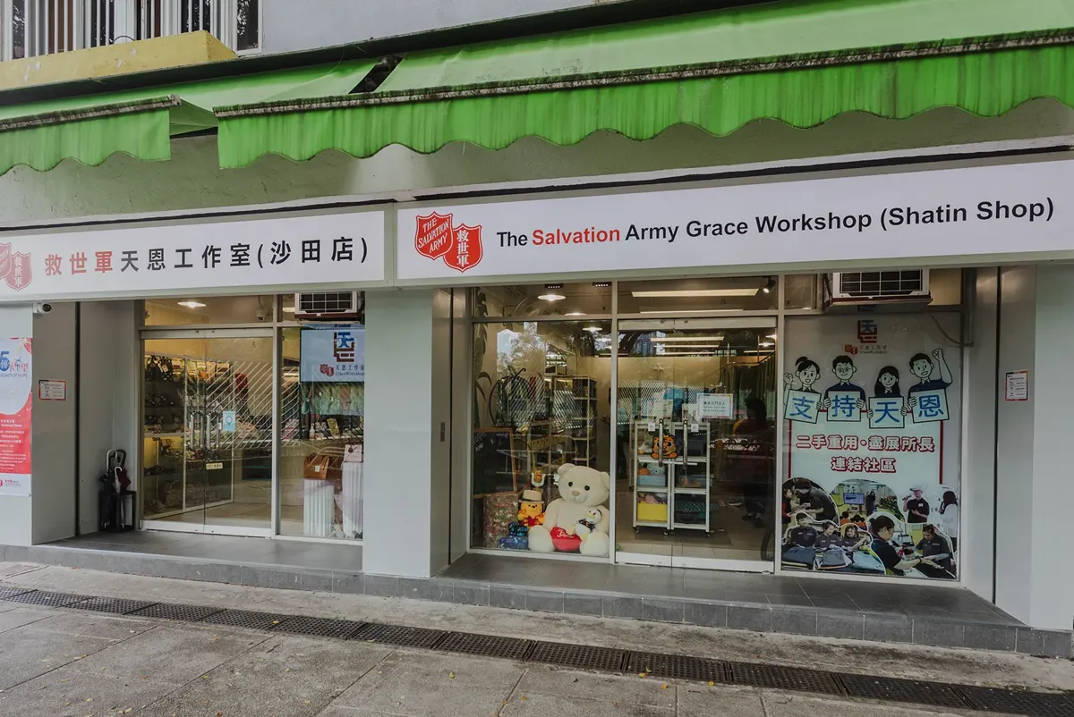 A store front with a green roof.