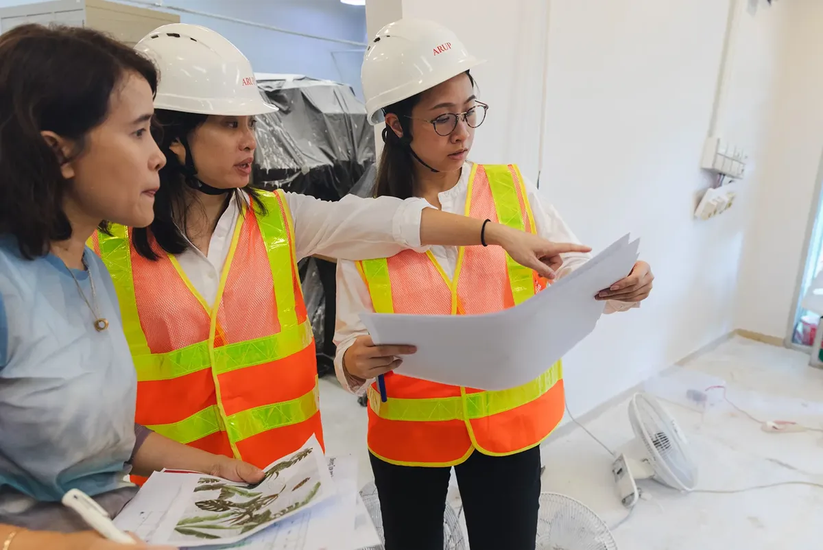 A group of women wearing hard hats.