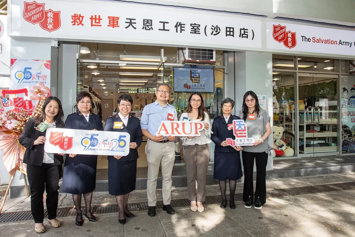 A group of people holding a sign.