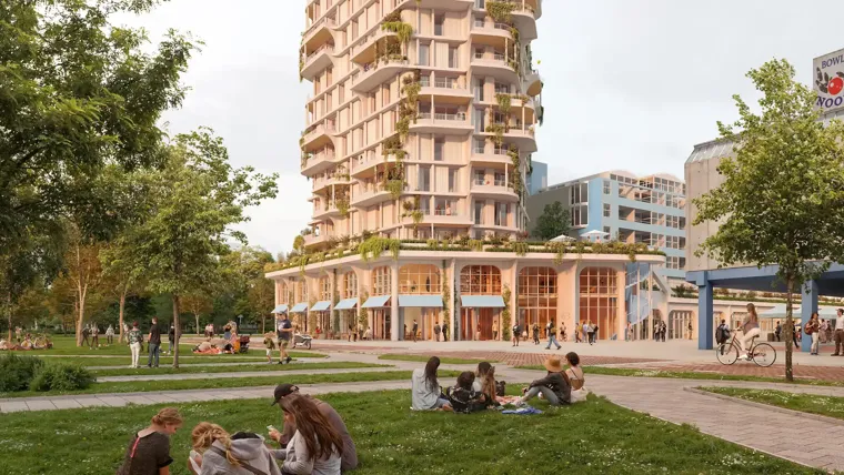 A group of people sitting on the grass in front of a building.
