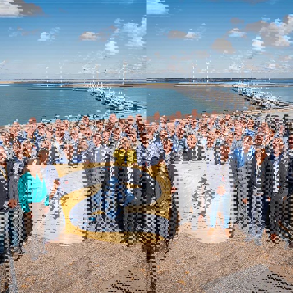 A group of people posing for a photo with a flag.