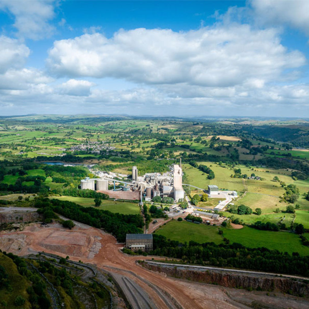 A large white building surrounded by trees.