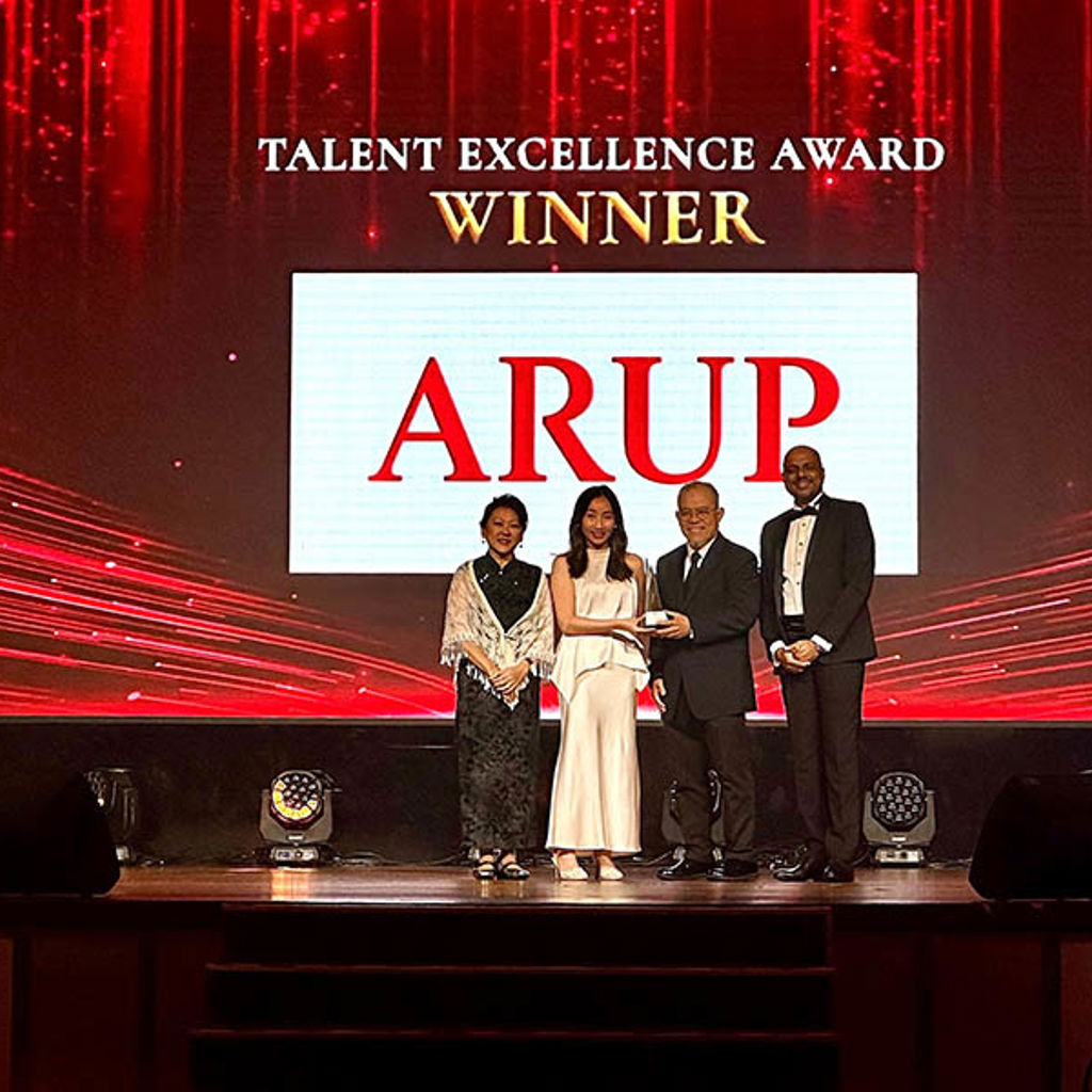 A group of people on stage accepting an award
