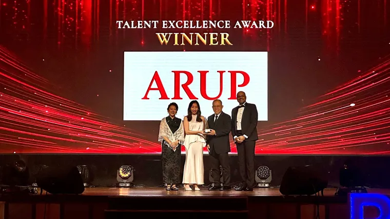 A group of people on stage accepting an award