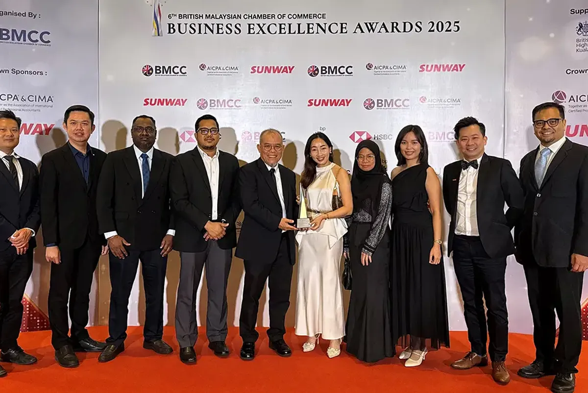 A large group of people holding an award at an event