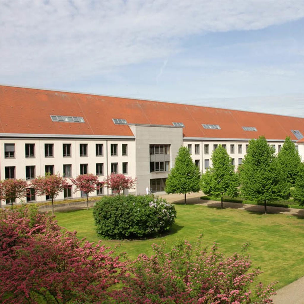 A building with a garden in front of it.