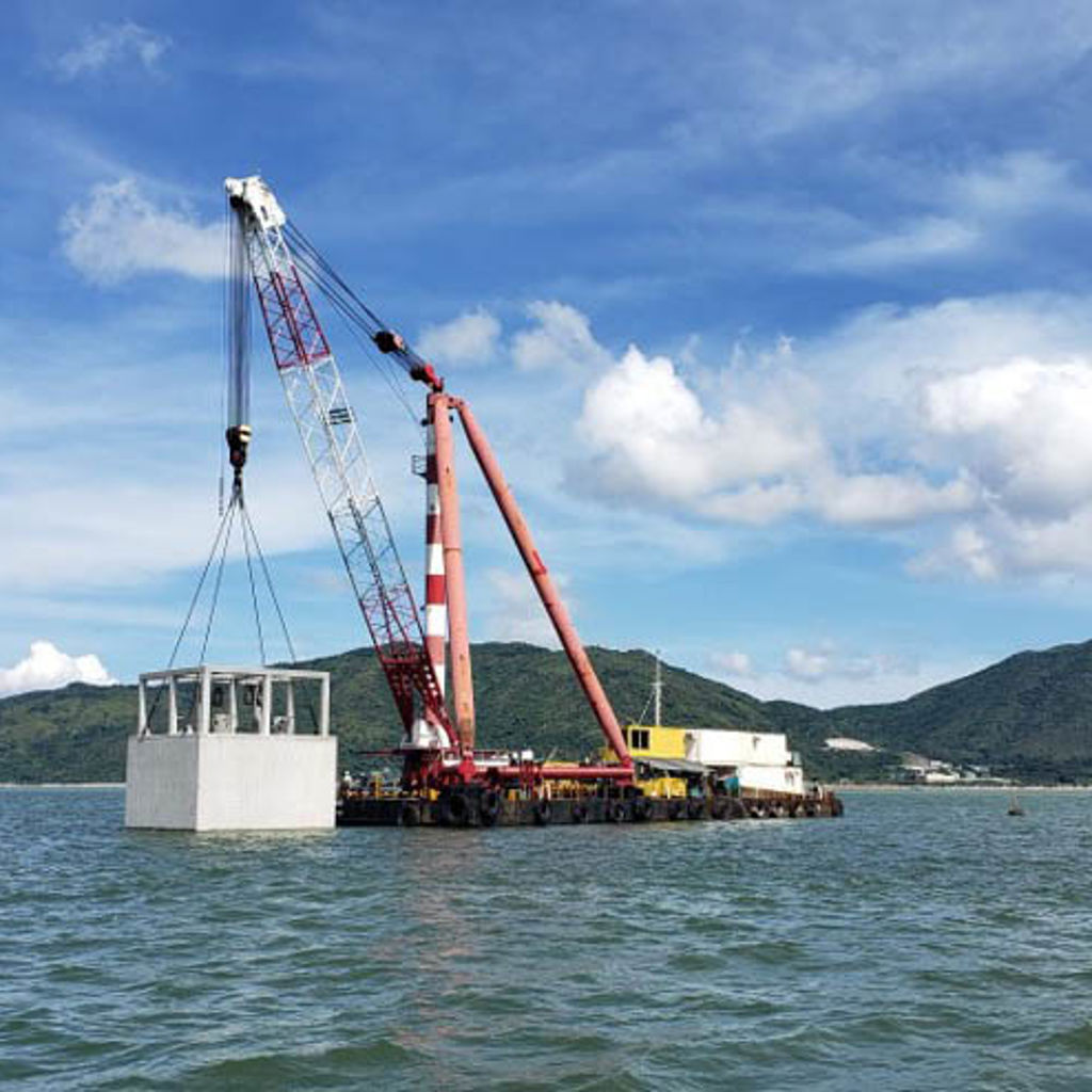 A large red crane on a dock.