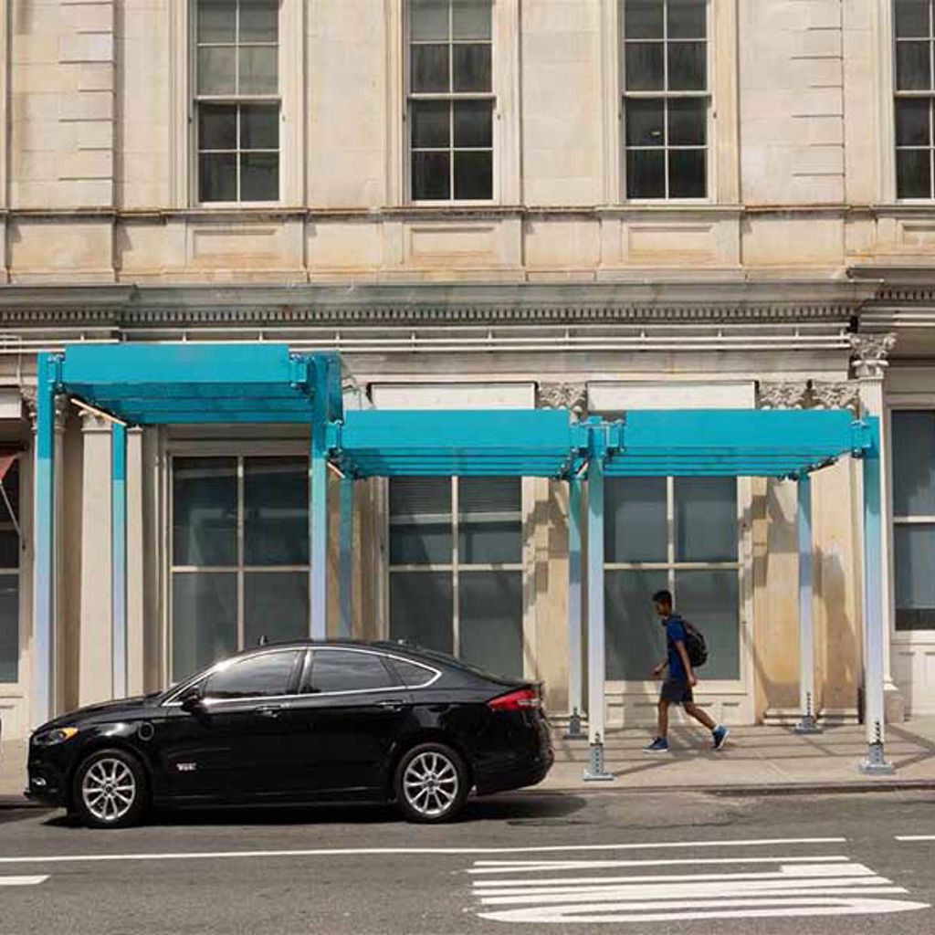 A black car parked in front of a building.