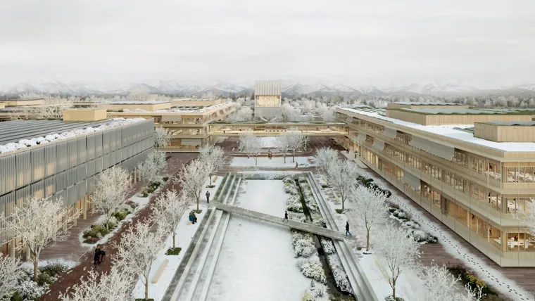 A courtyard with snow on the ground and buildings around it.