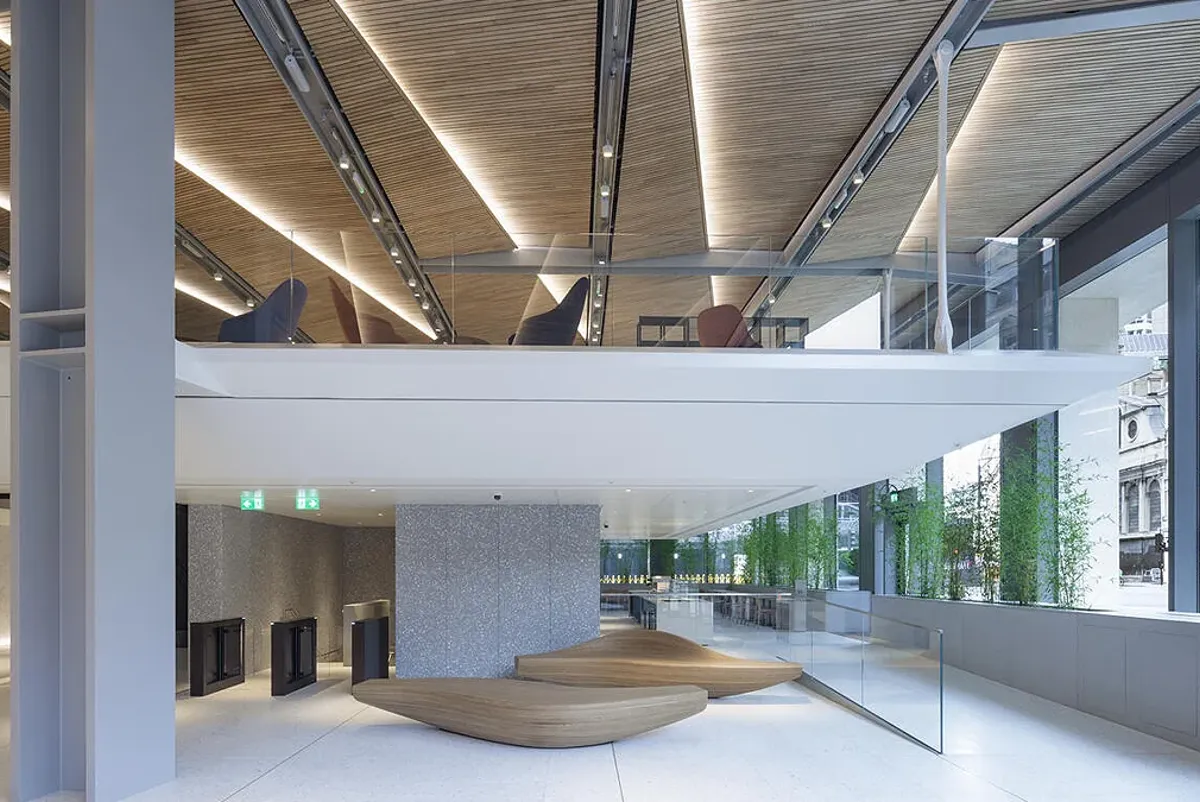A large white room with a large white floor and a large white pillar.